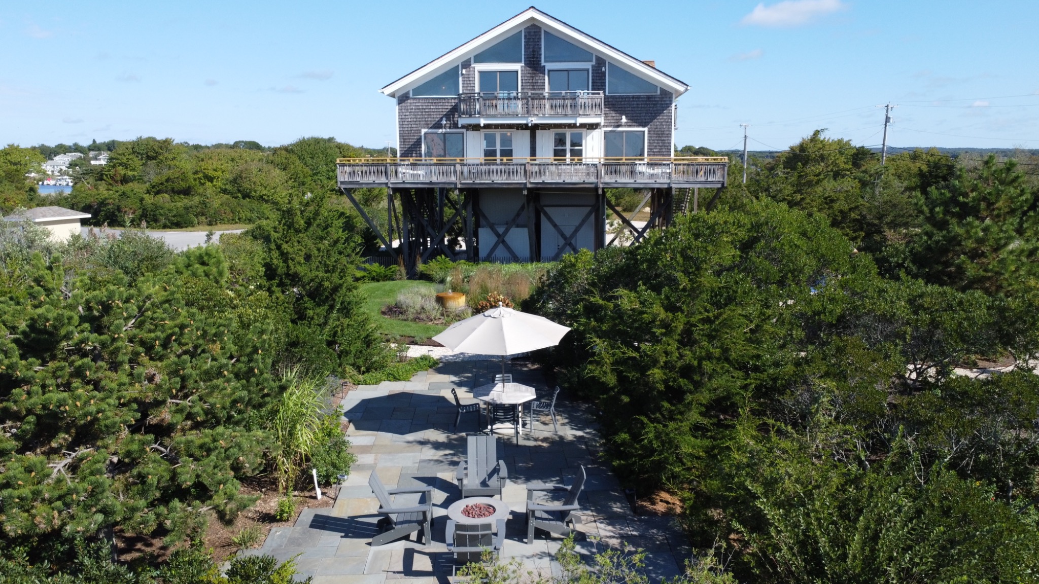 Surf House above winding garden paths and outdoor seating areas.
